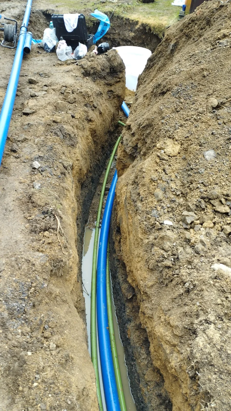 Vedení potrubí a jeho změna směru v otevřeném výkopu.