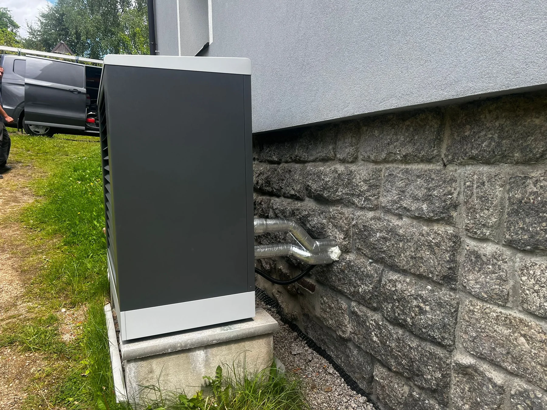 Kotelna bytového domu: Boční pohled na venkovní jednotku a její osazení.